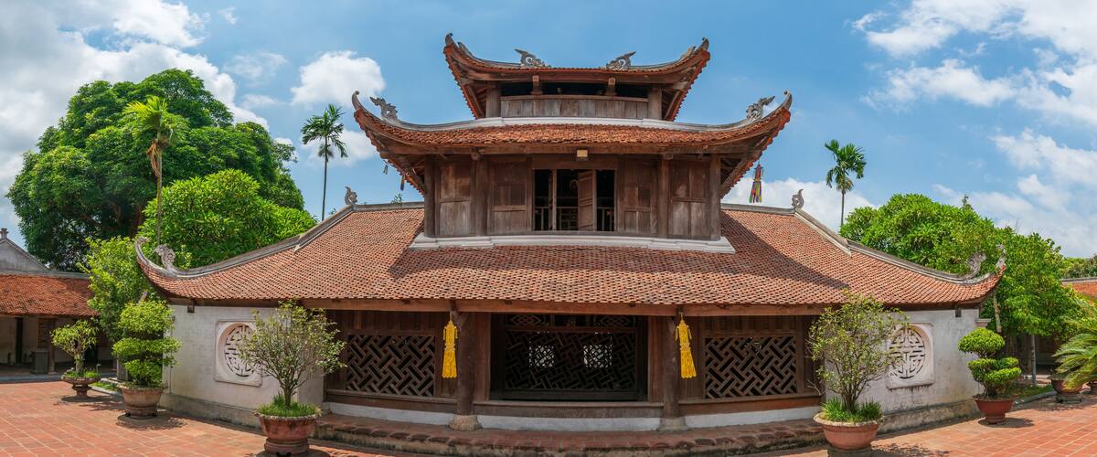 A traditional building with a tiled roof and ornate wooden eaves.