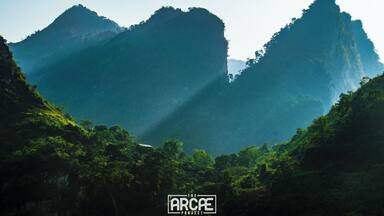 It was right after a very tight curve when I came upon this gorgeous landscape and since I was at the tail of the group, I decided to let go and stop by the side of the road--I just couldn't let this one pass!
With the Sun slowly going down the canyon that goes all the way into Ha Giang, the light gently seeped through the mountains, illuminating a tiny little house located on a small valley formed between two peaks.
That's what I call a great backyard!