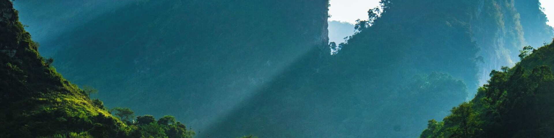 It was right after a very tight curve when I came upon this gorgeous landscape and since I was at the tail of the group, I decided to let go and stop by the side of the road--I just couldn't let this one pass!
With the Sun slowly going down the canyon that goes all the way into Ha Giang, the light gently seeped through the mountains, illuminating a tiny little house located on a small valley formed between two peaks.
That's what I call a great backyard!