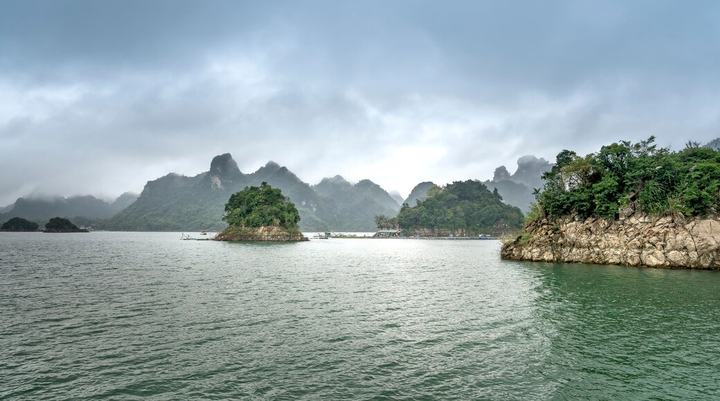 Na Hang lake in Tuyen Quang province, Viet Nam. This natural lake has a green watercolor. It is located between the majestic cliffs. Every year this place attracts many tourists to visit