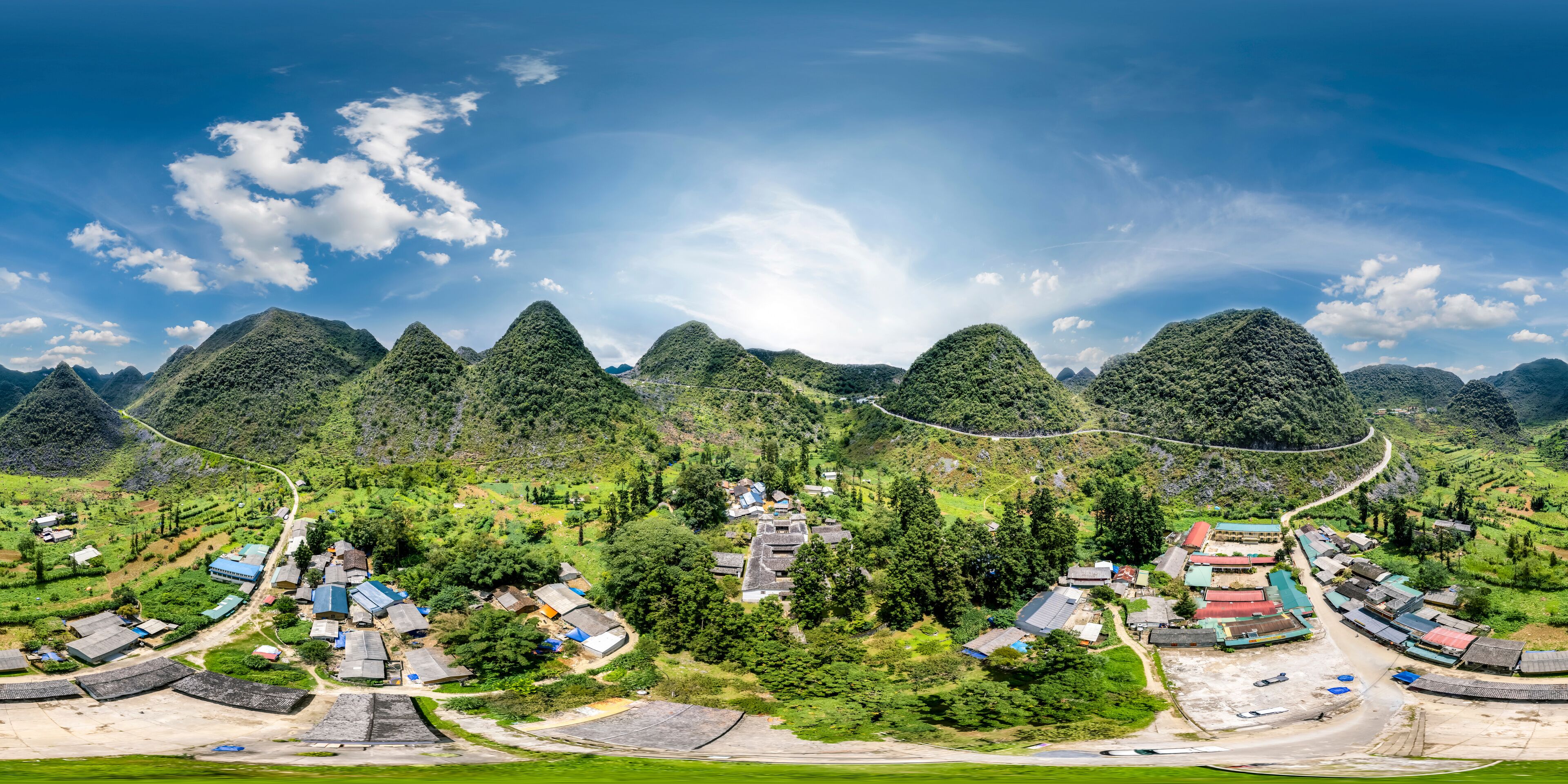 A mountainous landscape with a village nestled among the hills.