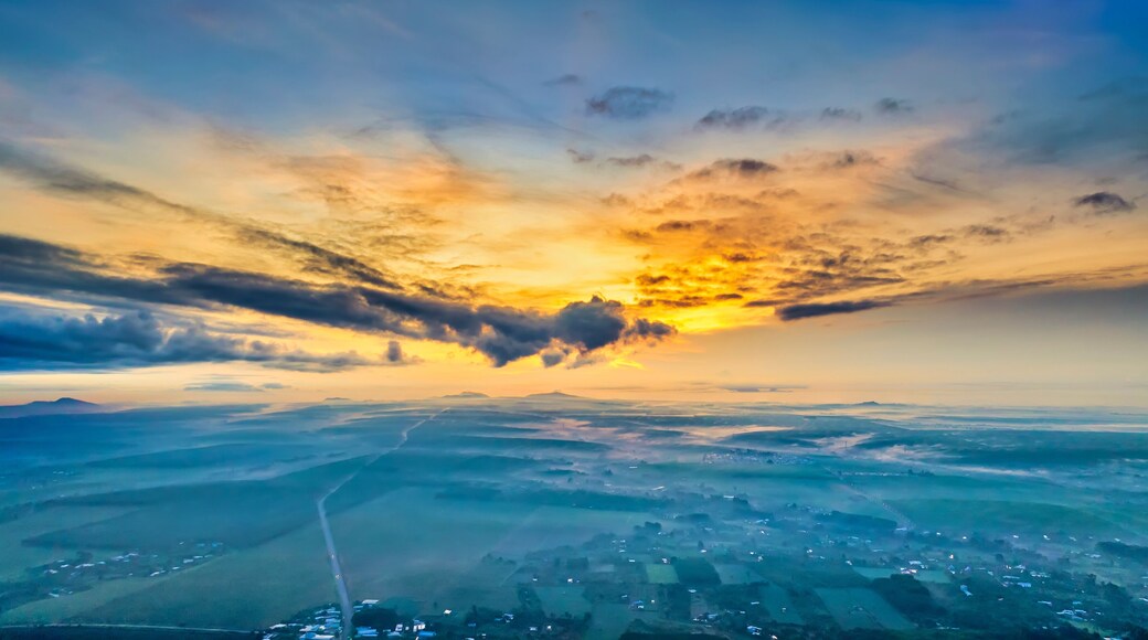 Beautiful sunrise sky above clouds with dramatic light in the suburbs near the future Long Thanh international airport. View from drone