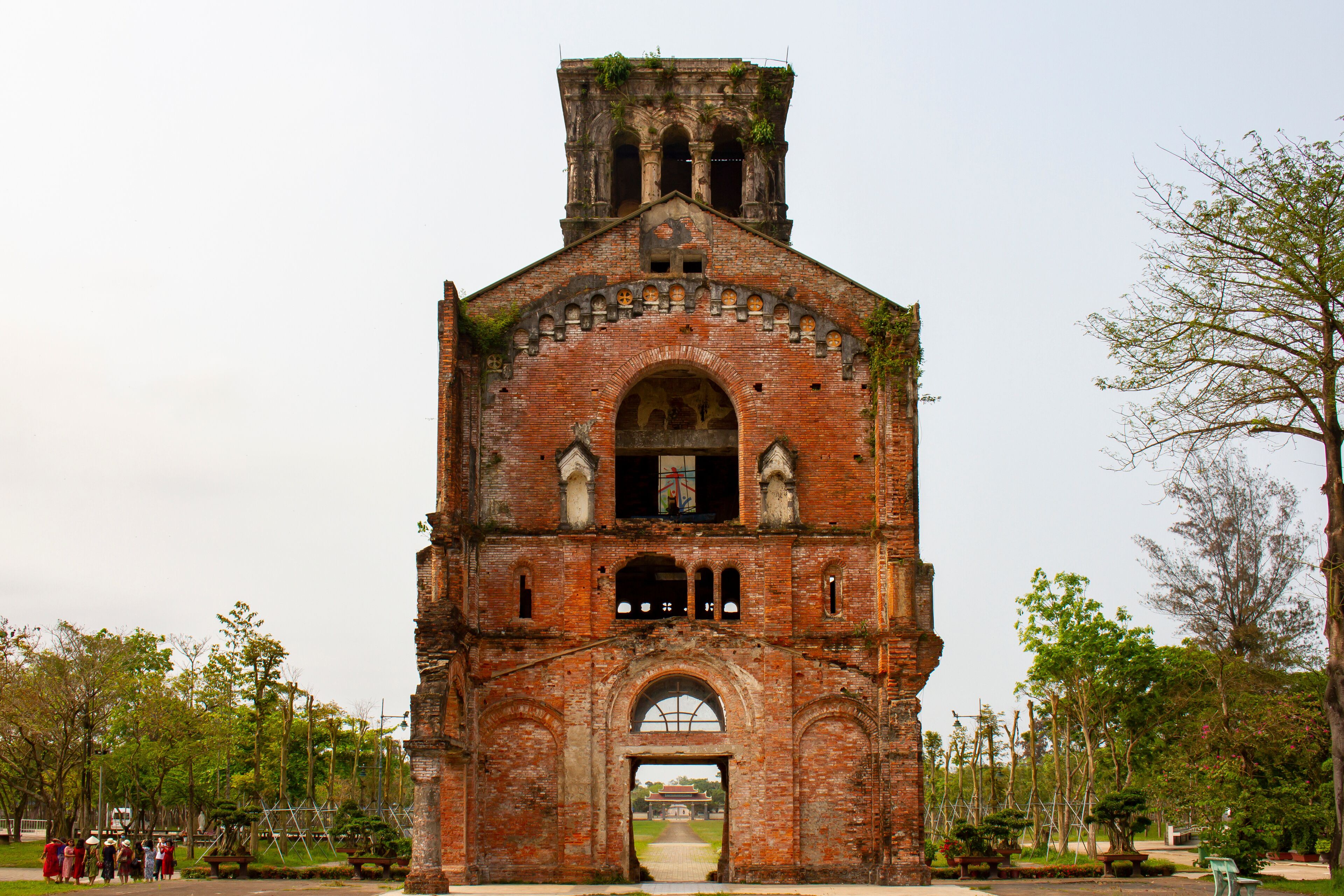 An old brick church with a bell tower and arched windows.