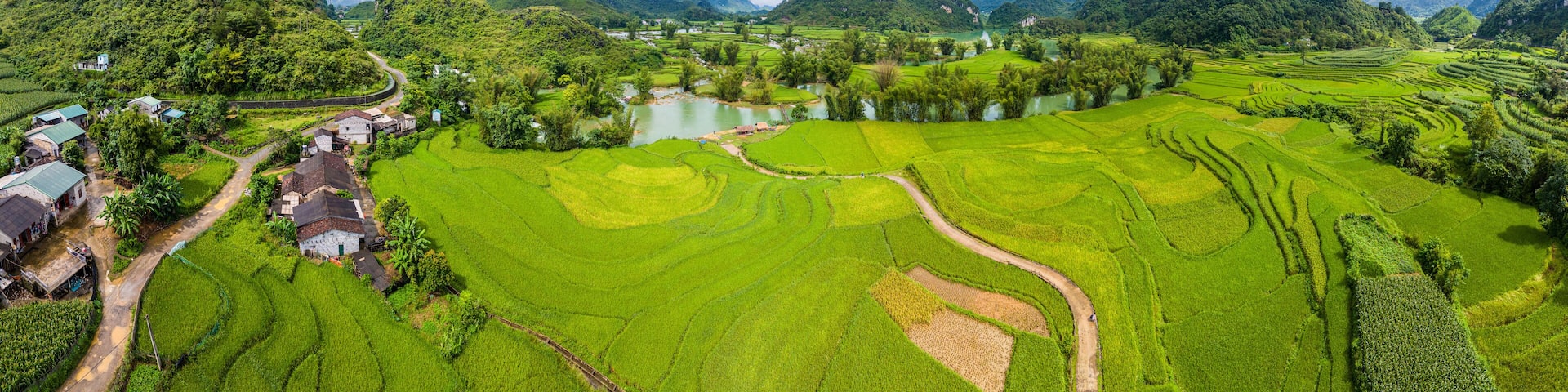 Aerial landscape in Quay Son river, Trung Khanh, Cao Bang, Vietnam with nature, green rice fields and rustic indigenous houses