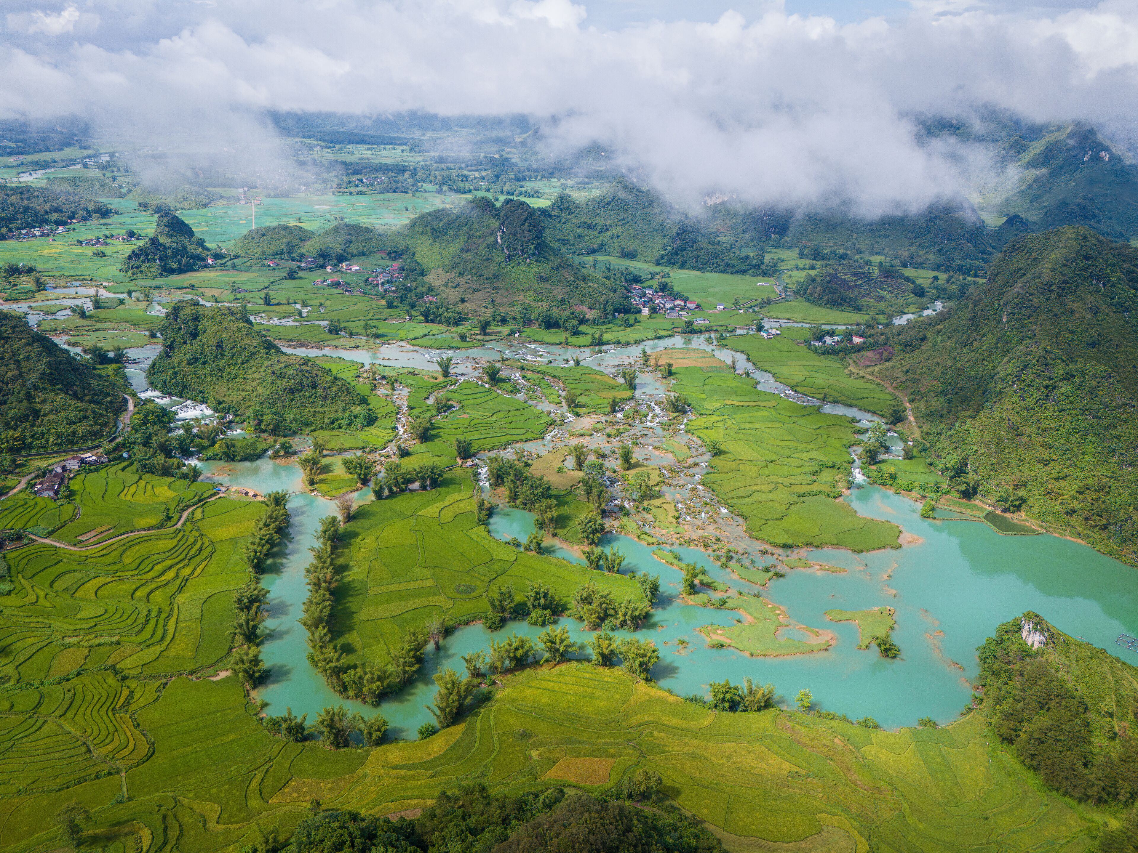 Aerial landscape in Quay Son river, Trung Khanh, Cao Bang, Vietnam with nature, green rice fields and rustic indigenous houses