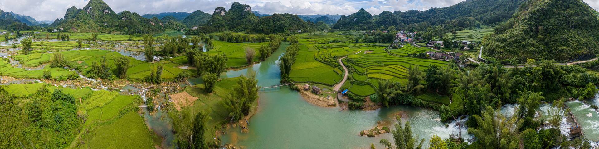 Aerial landscape in Quay Son river, Trung Khanh, Cao Bang, Vietnam with nature, green rice fields and rustic indigenous houses