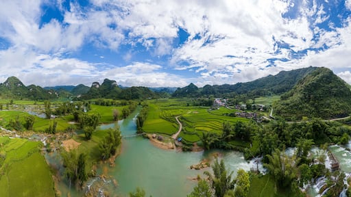 Aerial landscape in Quay Son river, Trung Khanh, Cao Bang, Vietnam with nature, green rice fields and rustic indigenous houses