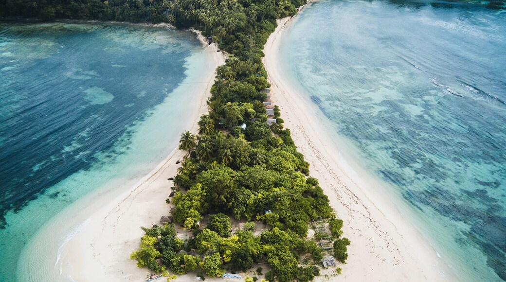 Aerial view of Cabgan Islet surrounded by turquoise water in Barobo, Surigao del Sur, Philippines