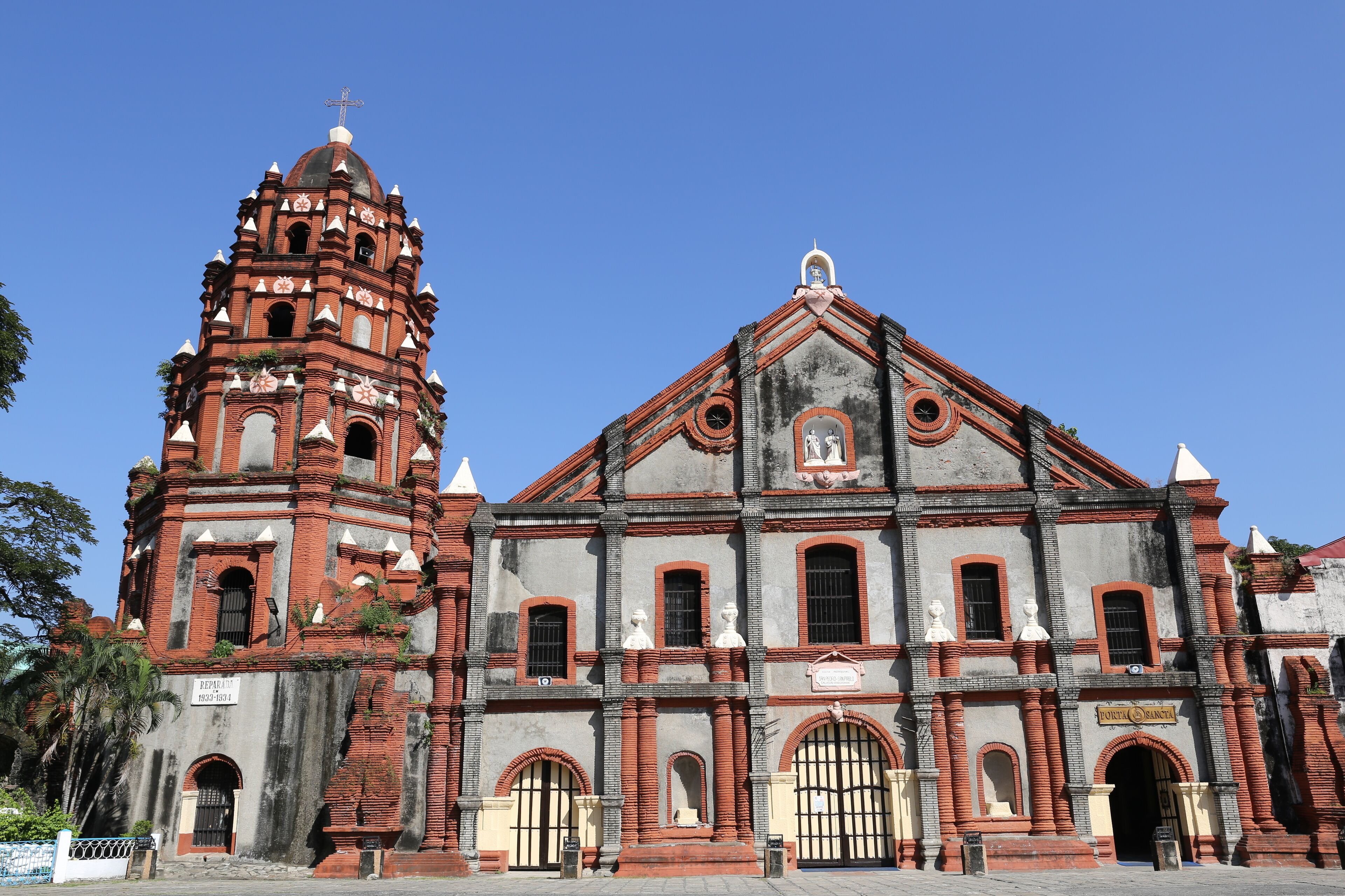 A historic church with a bell tower and a large arched entrance.