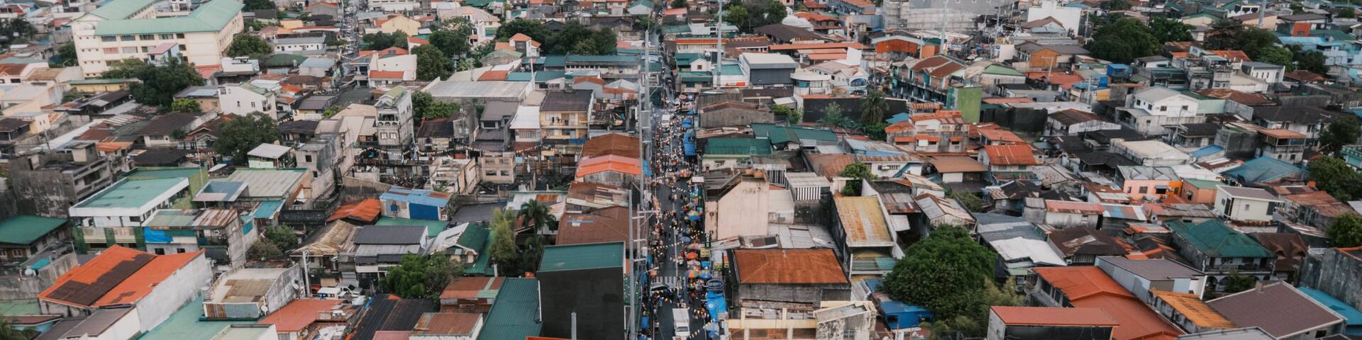 High-Angle Aerial View of a Bustling Street and Densely Packed Rooftops in Taytay, Rizal, Philippines