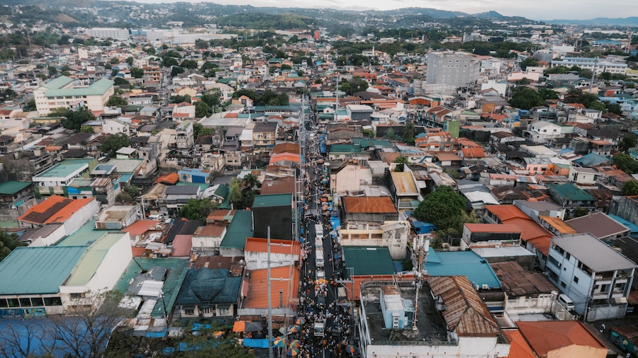 High-Angle Aerial View of a Bustling Street and Densely Packed Rooftops in Taytay, Rizal, Philippines