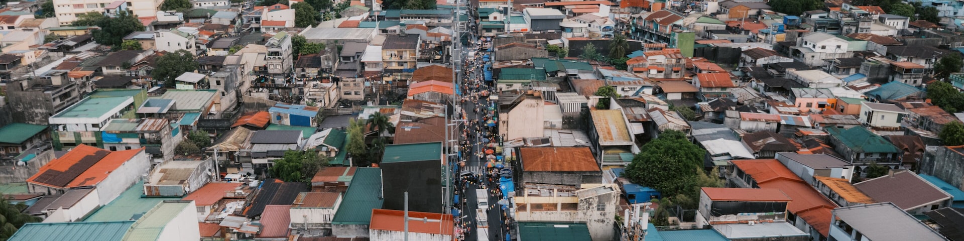 High-Angle Aerial View of a Bustling Street and Densely Packed Rooftops in Taytay, Rizal, Philippines