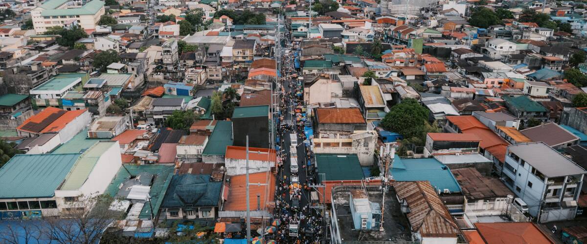 A densely packed urban area with numerous buildings and a busy street.