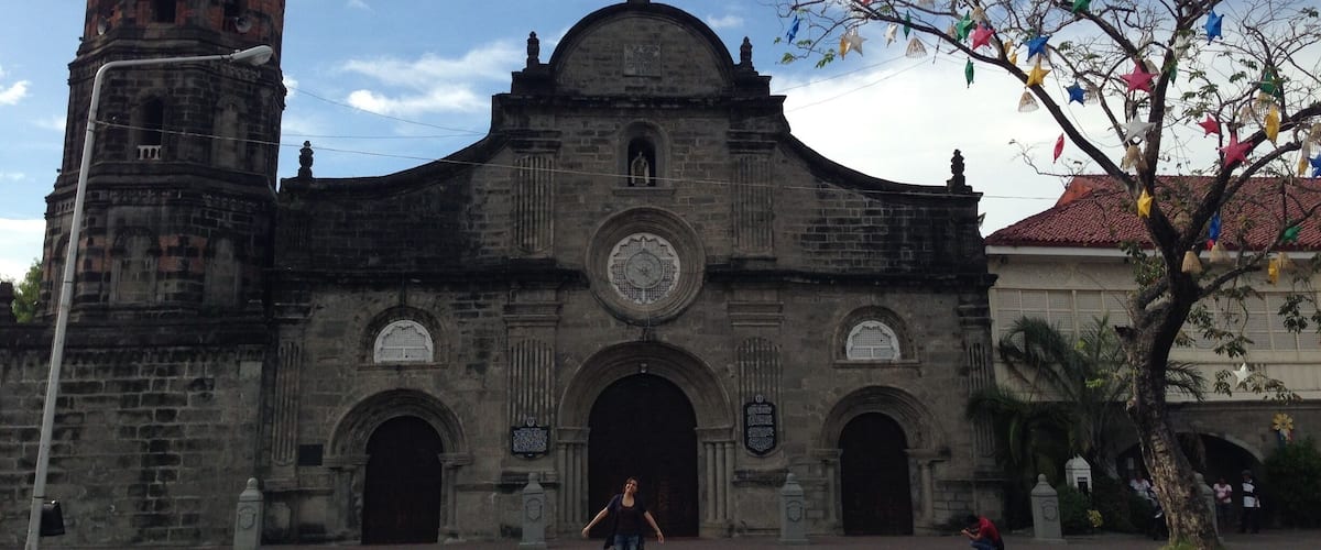 A historic church with a bell tower and a large dome.