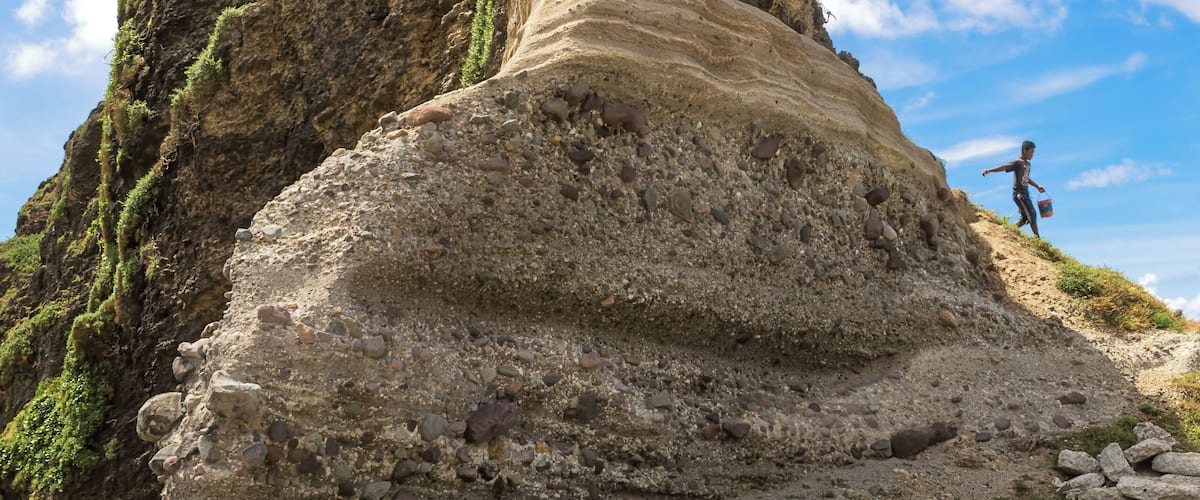 A goat herder and his goats on the Alapad Rock Formation in Sabtang Island, Batanes, one of the northernmost inhabited isles in the Philippines.