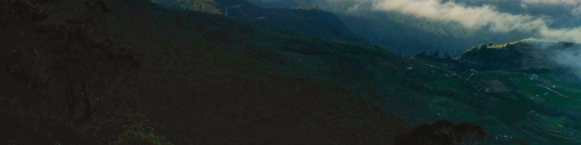 A mountain range with clouds below.