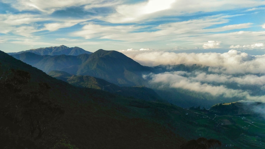 A mountain range with clouds below.