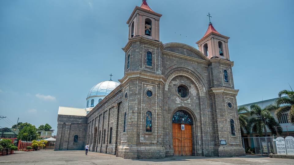 A historic church with a large dome and two bell towers.