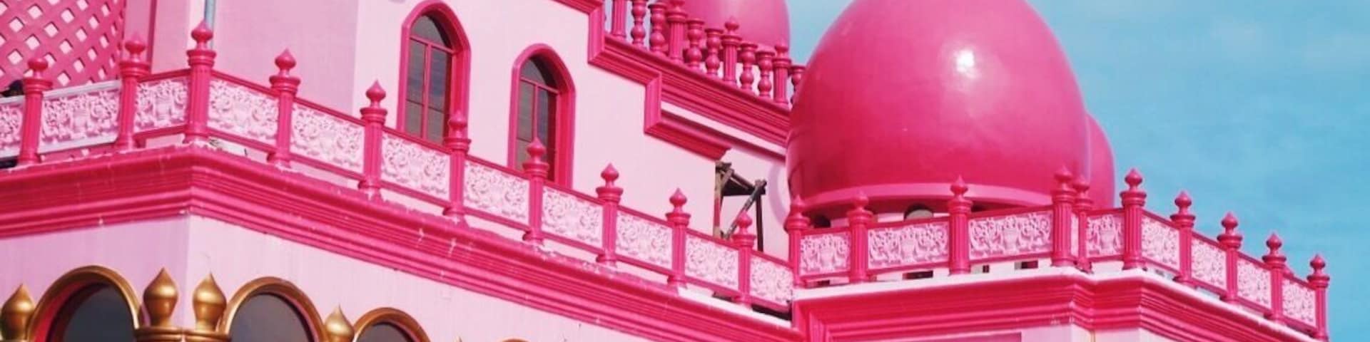 In the Philippines, specifically in Datu Saudi Ampatuan, Maguindanao, a noteworthy mosque that stands for peace has become quite a spectacular attraction. Can you guess what color? Yes. This is the Pink Mosque, or formally called, Masjid Dimaukom.
Masjid Dimaukom is clad in vibrant shades of pink – from the carnation-colored walls adorned by golden arches of its glass windows, to the lively cerise domes accented with silver spires, as well as silver star and crescents that face east. But that’s not it. The spacious interiors dominated by pink hues from its walls to the high ceilings, the shiny carmine of the tiled flooring, the bold golden pillars – the inside is equally captivating. This edifice is certainly an eye candy from inside out.
Beyond the structure’s aesthetic appeal, the Pink Mosque was built, primarily, as a sacred place of prayer, and also a symbol of peace. A unique structure that exemplifies harmony among Filipinos, regardless of religion, ethnicity, culture, and social class. The mosque is a brainchild of a man who believes in his love for the country, its people, and above all, the love for Allah.