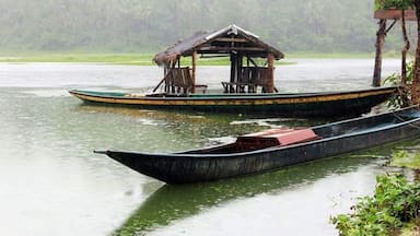 A river with two boats, one with a shelter and the other without.