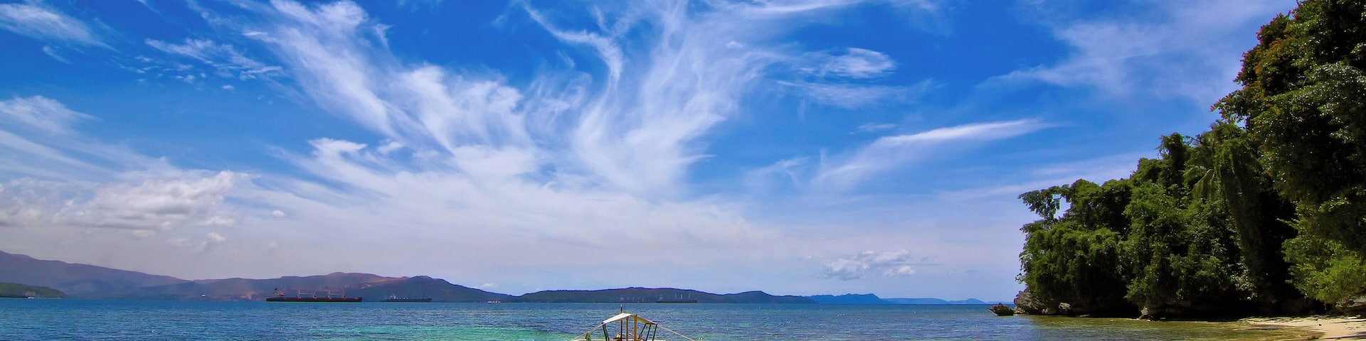 The sky whips up an artful cloud display to complement the beauty and serenity of Candido Beach - one of the Philippines lesser known beaches. A boat ride away from the town of Carrascal in Surigao del Sur, I was very fortunate to have found this "hidden gem" under such great weather.