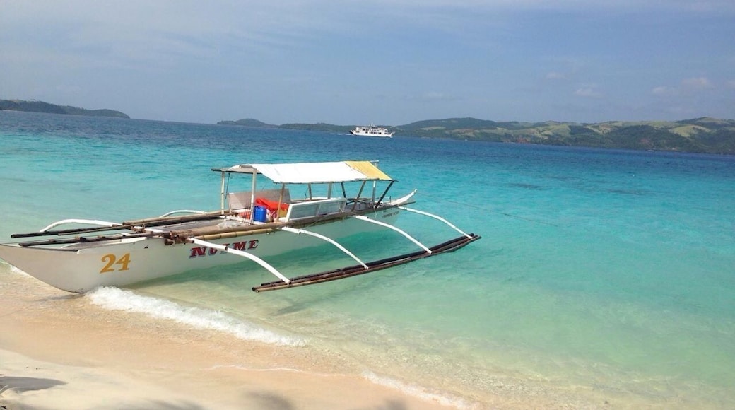 The amazing bluish green color of the water and the pinkish sand of Tikling Island