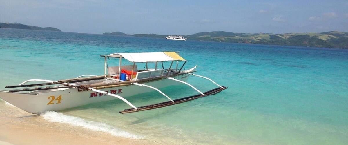 The amazing bluish green color of the water and the pinkish sand of Tikling Island