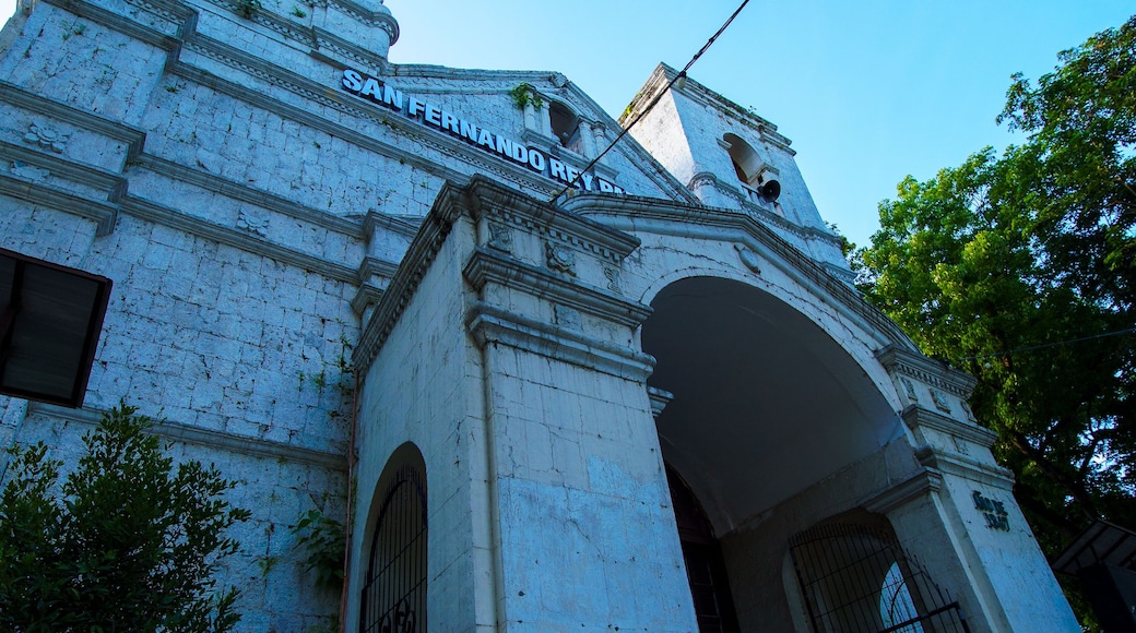 A historic building with a white facade, arched entrance, and a sign reading 'SAN FERNANDO REY.'