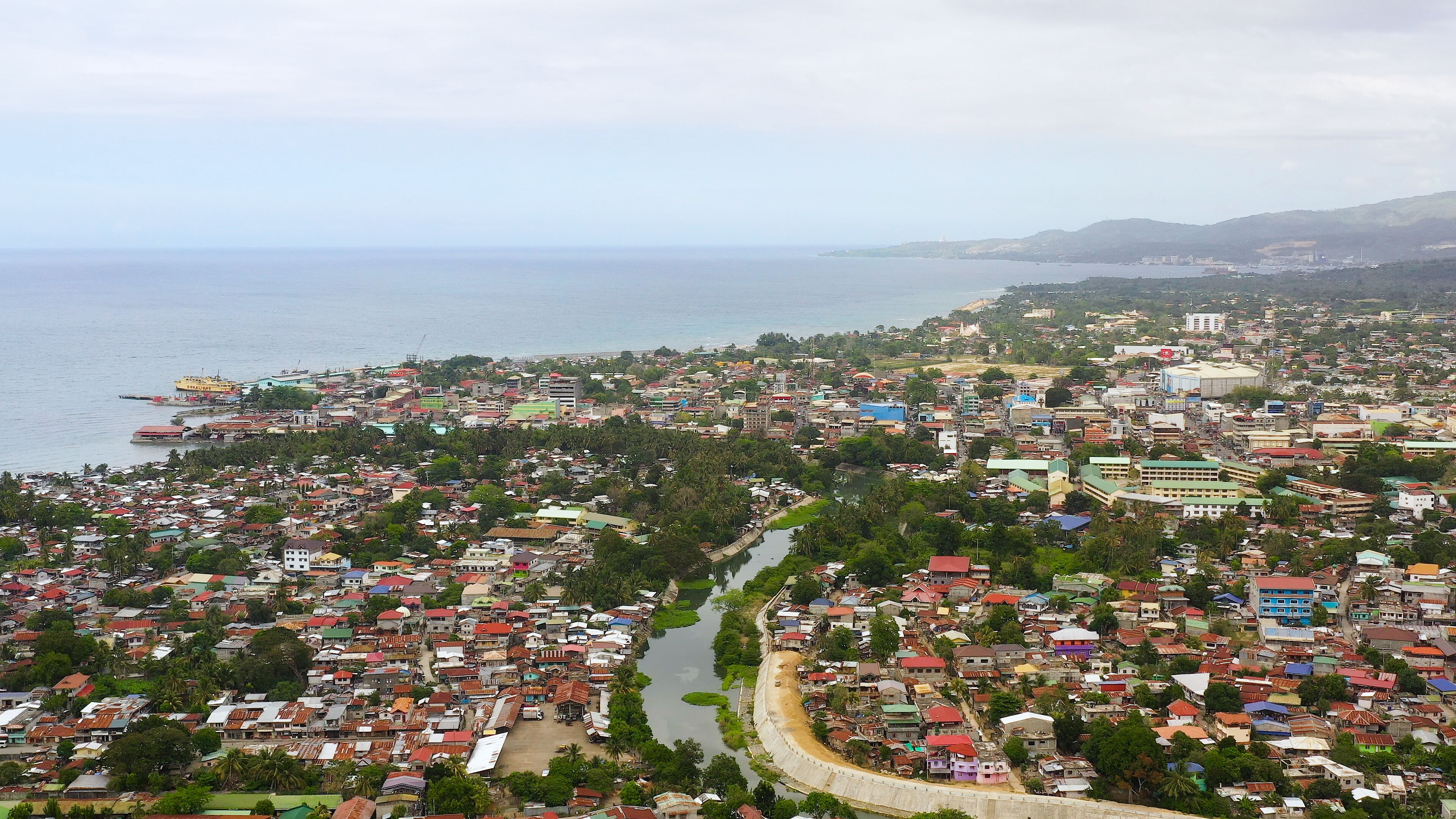 Panorama of the city of Iligan against the background of the sea and mountains. Iligan City, Lanao del Norte.