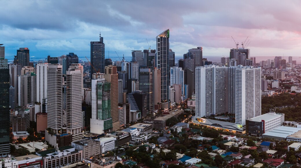 Panoramic view of Makati urban skyline at sunset, Manila, Philippines