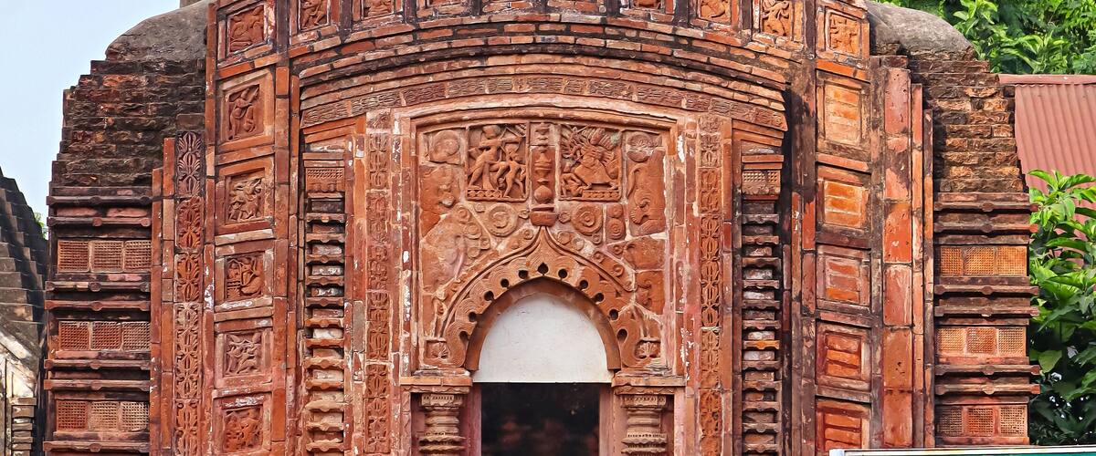 A temple with intricate carvings and a pointed roof.