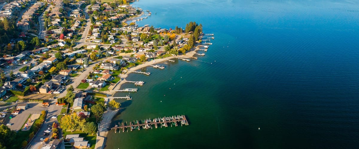Okanagan Lake which includes landscape views, a small town or village and a lake or waterhole