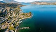 Okanagan Lake which includes landscape views, a small town or village and a lake or waterhole