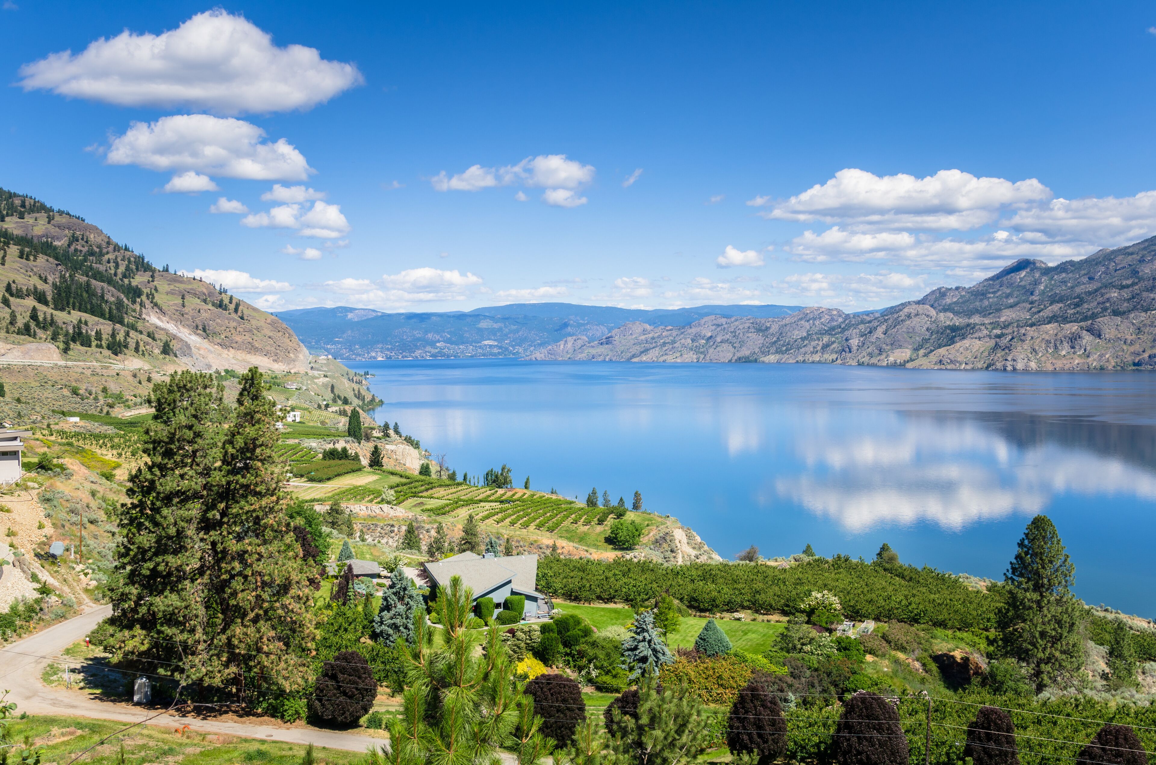 View of the Okanagan Lake under Blue Sky on a Sunny Summer Day and Reflection in Water. Penticton, BC, Canada.