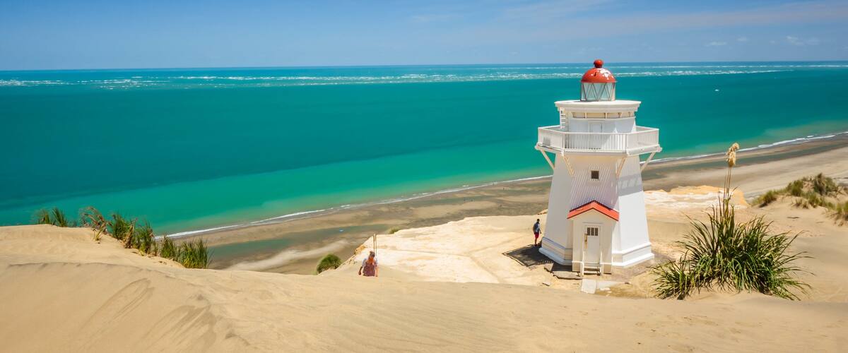 Pouto featuring general coastal views, a sandy beach and a lighthouse