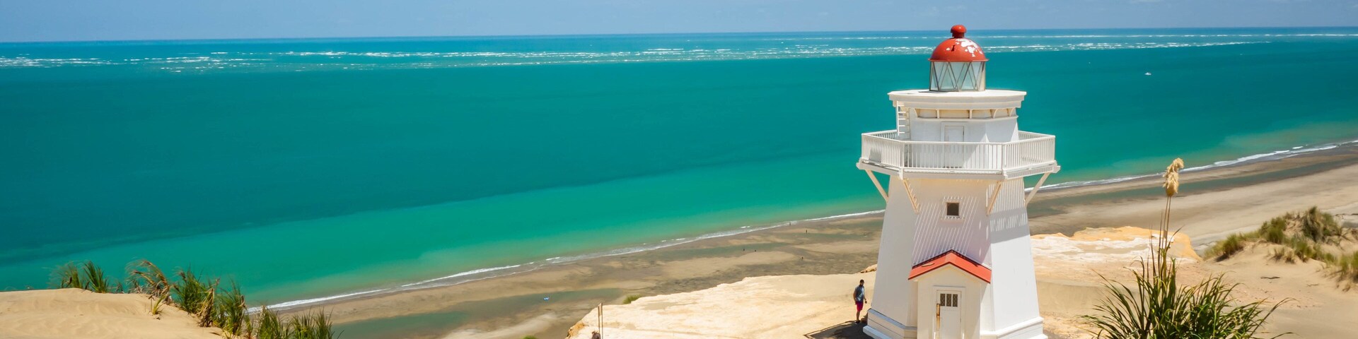 Pouto featuring general coastal views, a sandy beach and a lighthouse