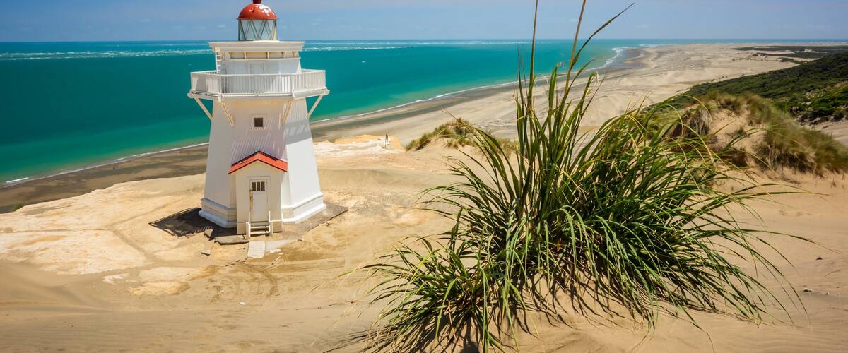 Pouto which includes general coastal views, a lighthouse and a sandy beach