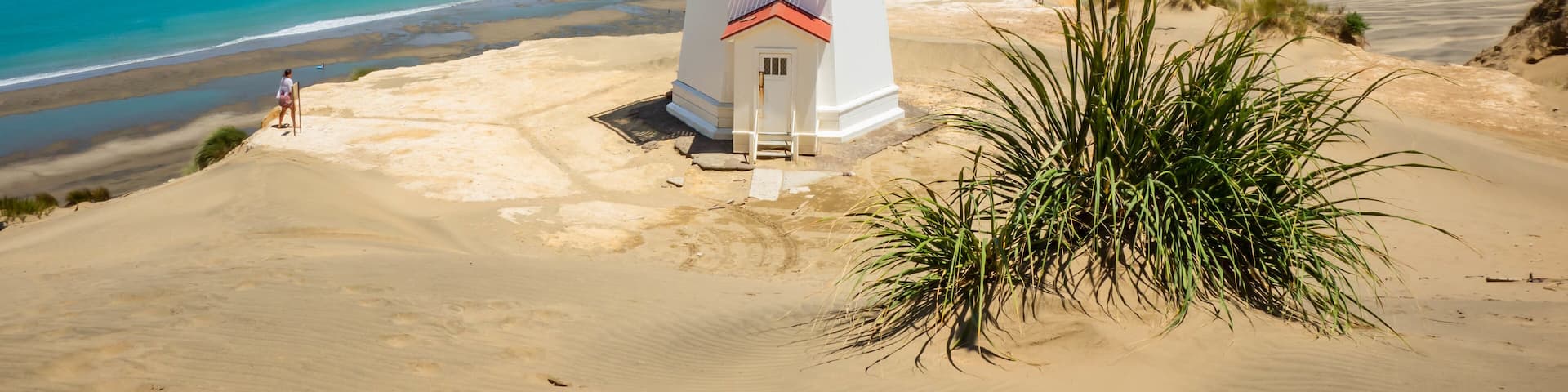 Pouto featuring a lighthouse, a sandy beach and general coastal views