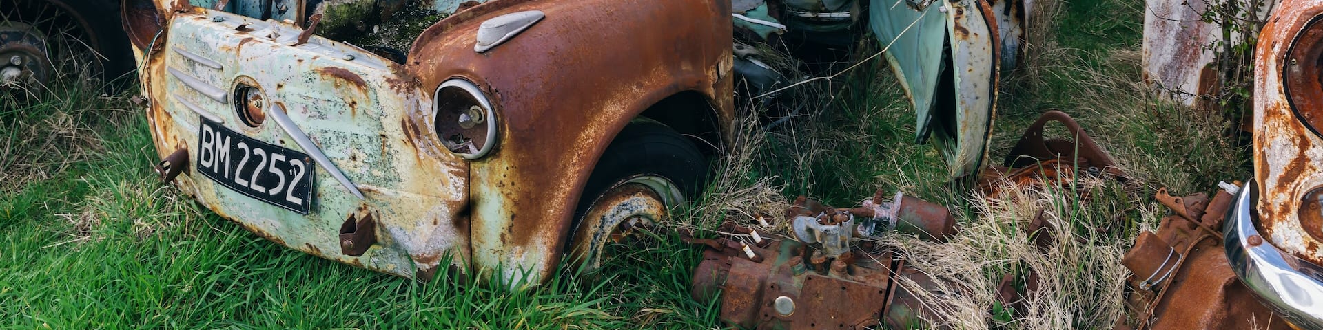 Abandoned and rusted classic cars in the The historical Horopito Motor Wreckers - Smash Palace, near Raetihi, Manawatu-Wanganui, New Zealand.