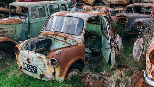 Abandoned and rusted classic cars in the The historical Horopito Motor Wreckers - Smash Palace, near Raetihi, Manawatu-Wanganui, New Zealand.