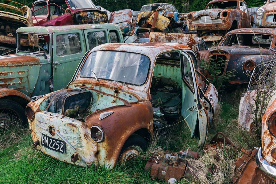 Abandoned and rusted classic cars in the The historical Horopito Motor Wreckers - Smash Palace, near Raetihi, Manawatu-Wanganui, New Zealand.
