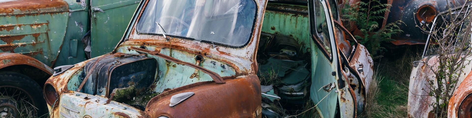 Abandoned and rusted classic cars in the The historical Horopito Motor Wreckers - Smash Palace, near Raetihi, Manawatu-Wanganui, New Zealand.