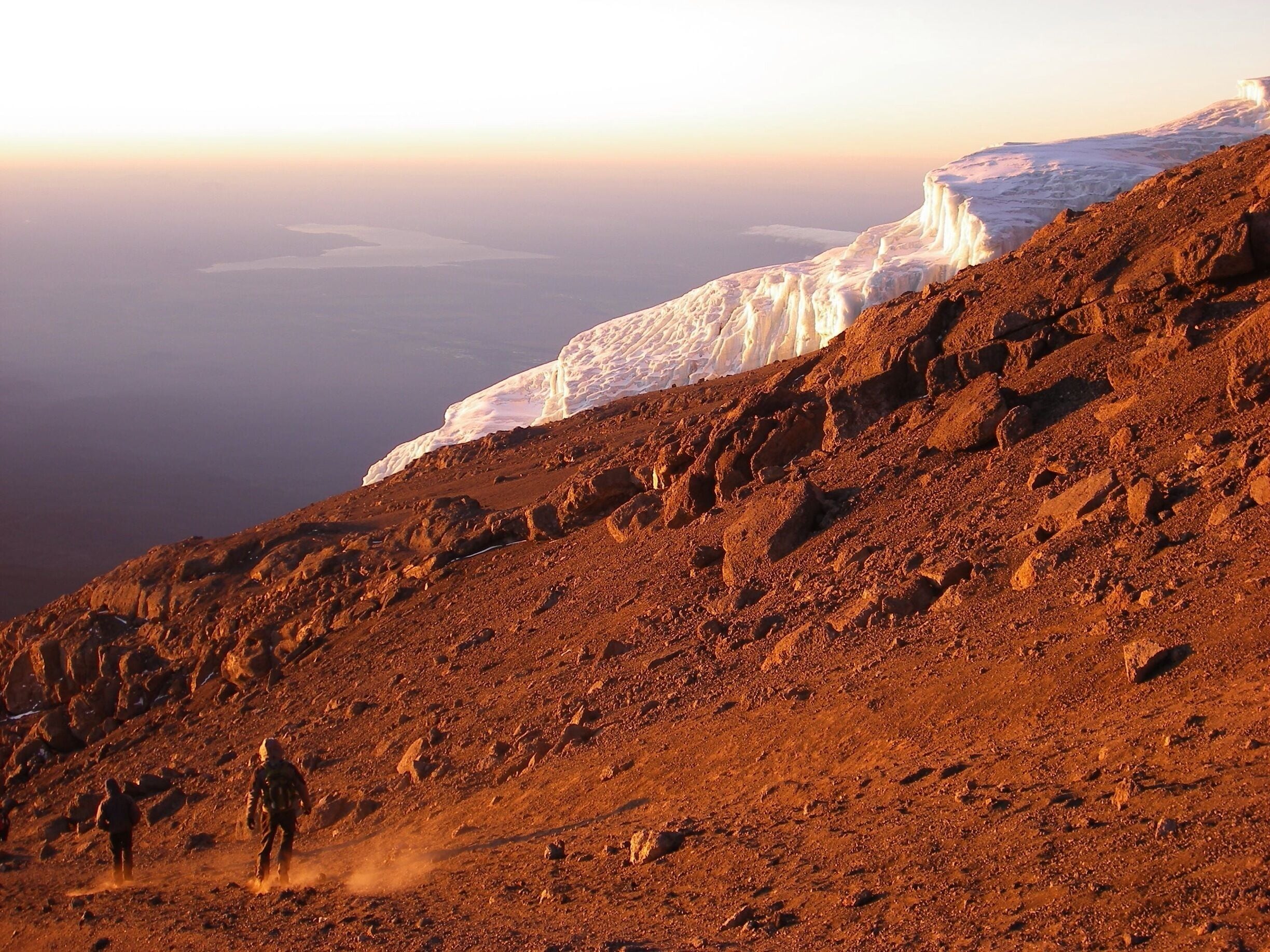 Descending while sun rises after reaching the top of Africa's highest peak, Mt. Kilimanjaro! (5895m) 