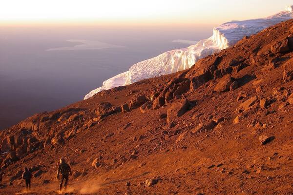 Descending while sun rises after reaching the top of Africa's highest peak, Mt. Kilimanjaro! (5895m)