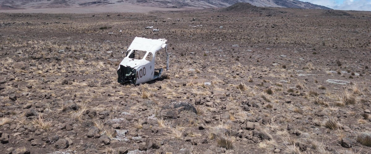 The remains of a crashed plane on The Saddle between Mawenzi and Uhuru peaks, with our final target, Uhuru, looming ahead.