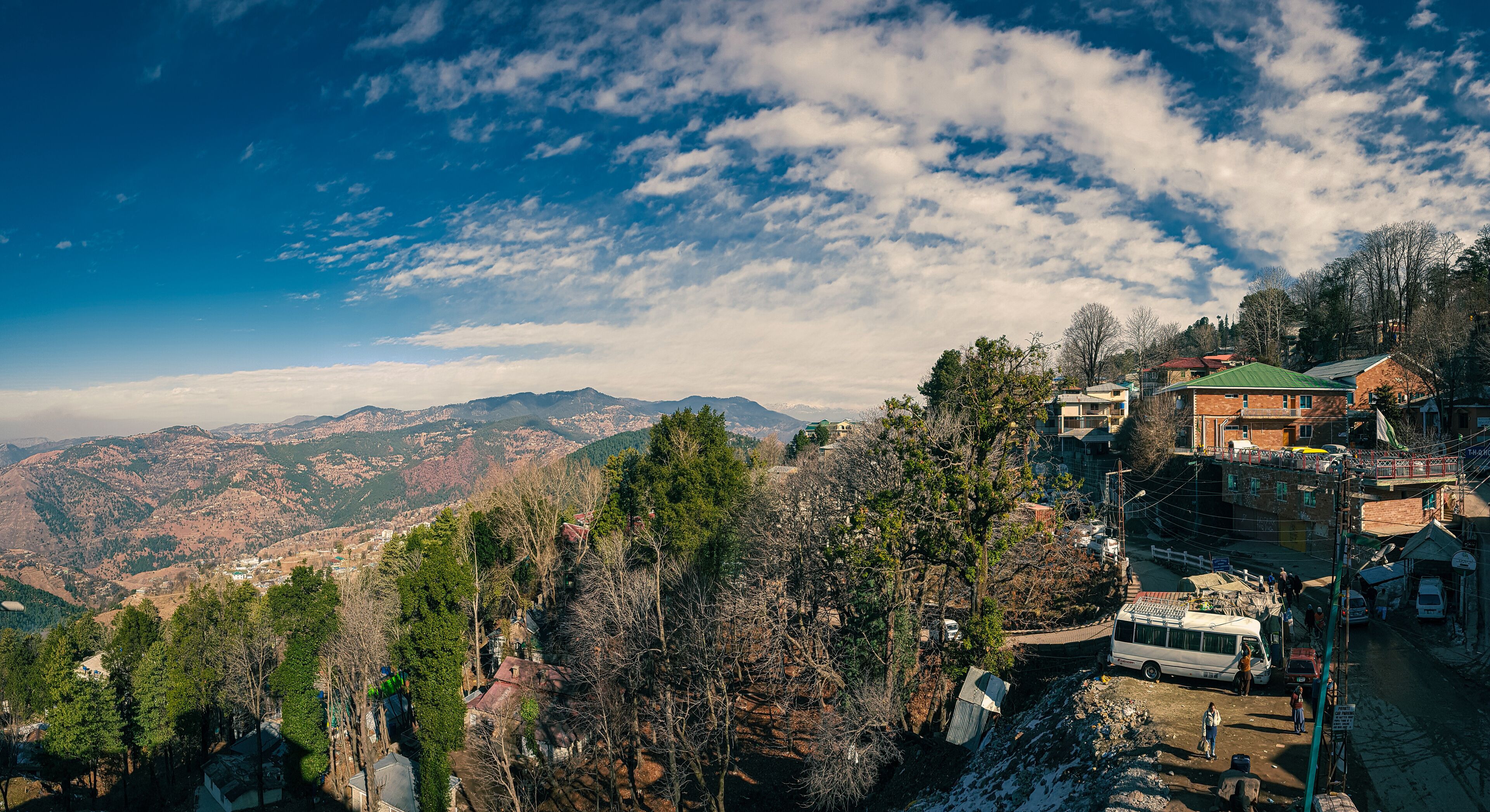 A mountainous landscape with a village nestled among trees.