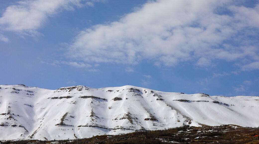Beautiful view of the Bsharri District mountains covered in snow on a sunny day