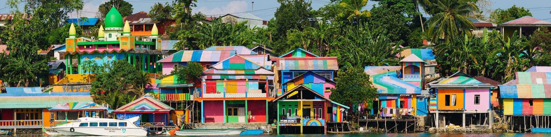 Raimbow village at Tual administrative town of Kei Kecil island, Moluccas, Indonesia. A colorful slum on the river bank called Kampung Pelangi. High resolution panorama.