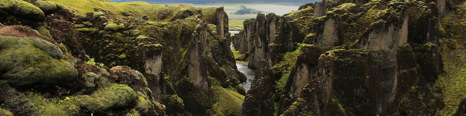 Vista of a winding river through a moss-covered valley – panorama of Fjadrárgljúfur Ice Age canyon in Iceland