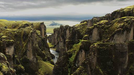 Vista of a winding river through a moss-covered valley – panorama of Fjadrárgljúfur Ice Age canyon in Iceland